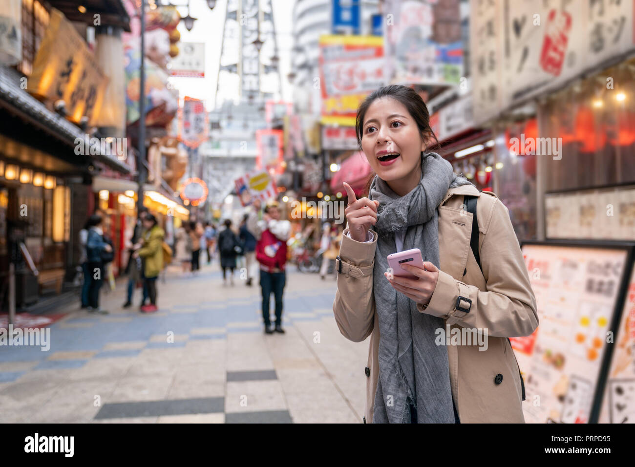 female tourist holding her smartphone with map in it, and she found the place where she wants to go Stock Photo