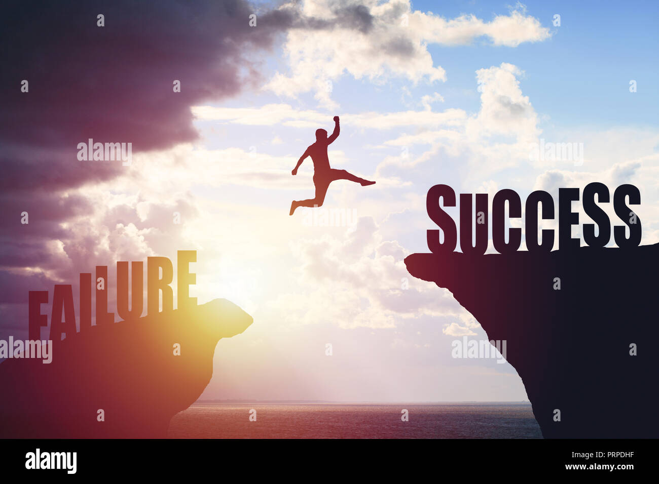 Silhouette of business man jump to success text over a beautiful view  mountain background Stock Photo - Alamy