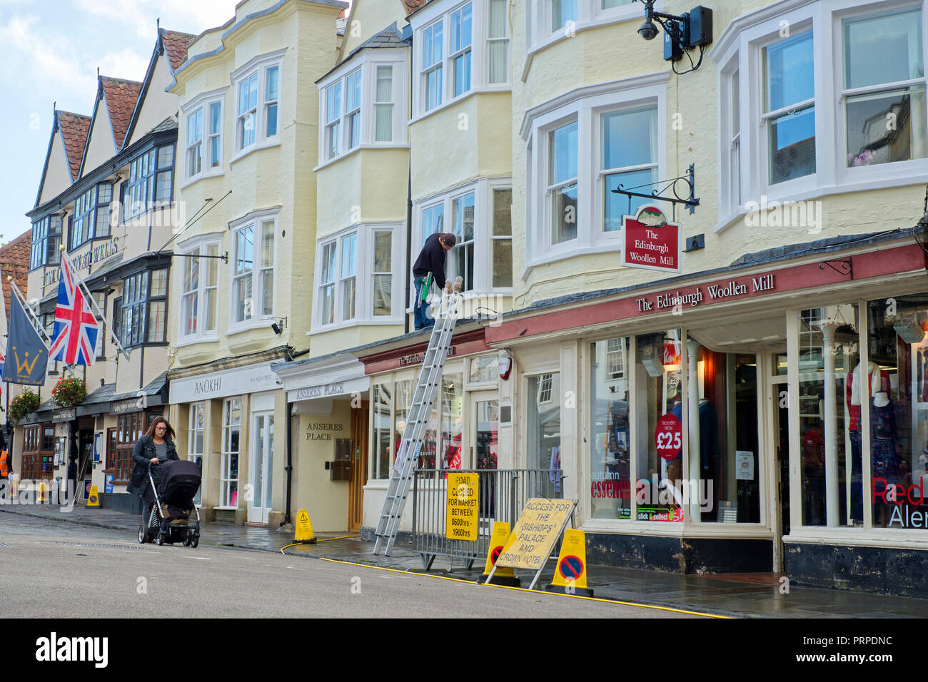 A Window Cleaner cleaning windows on a building in Wells, Somerset, UK Stock Photo