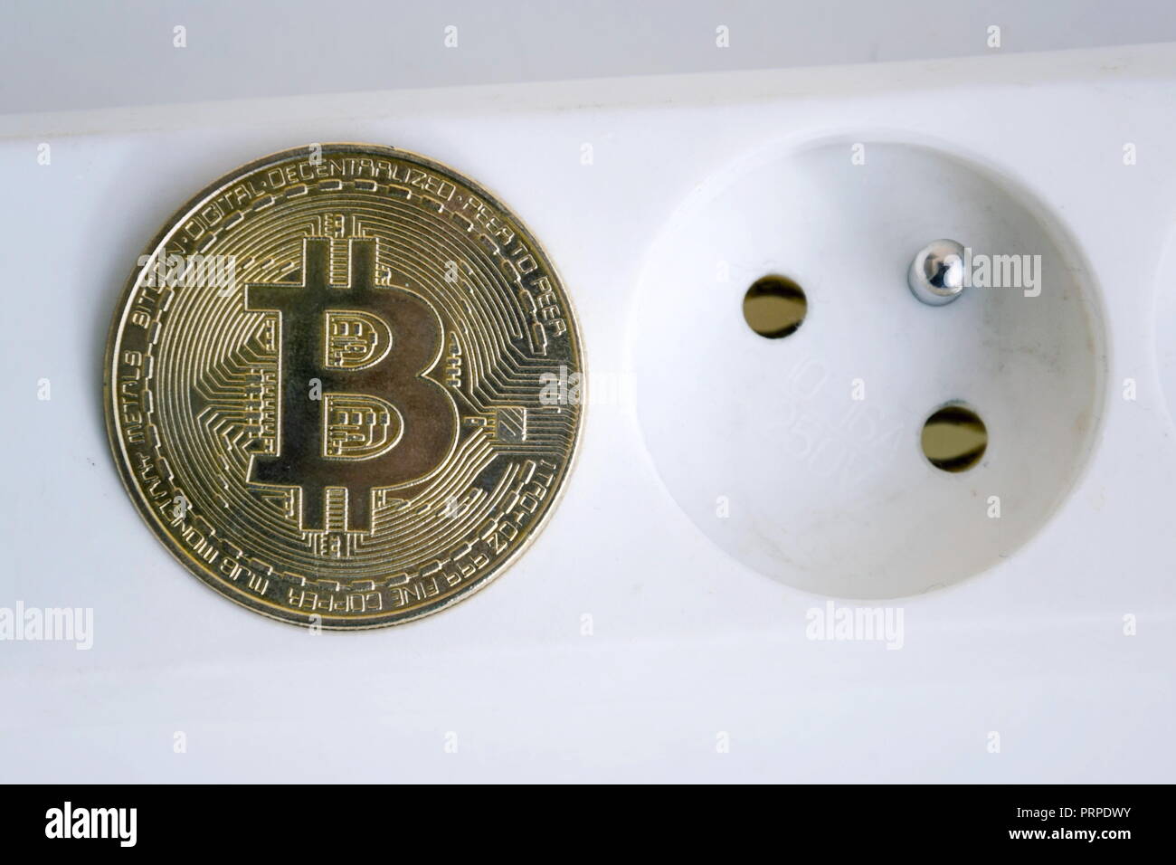 Bitcoin coin lying on power strip extension cord with two empty sockets,  cryptocurrency investing, energy consumption and footprint concept,  isolated Stock Photo - Alamy