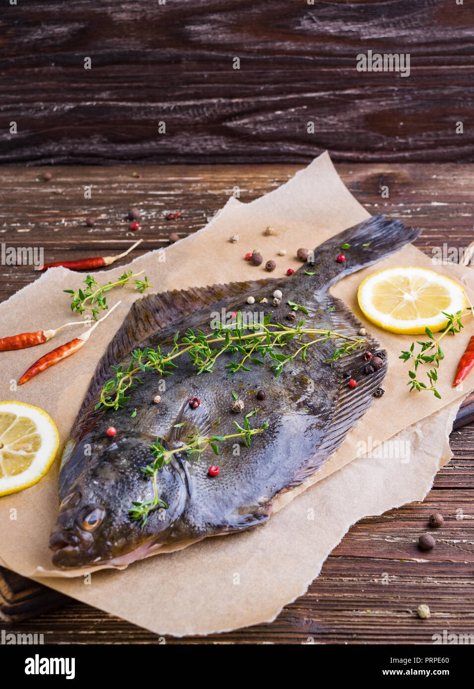 Raw flounder plaice fish (flatfish). Cooking process concept. Flounder