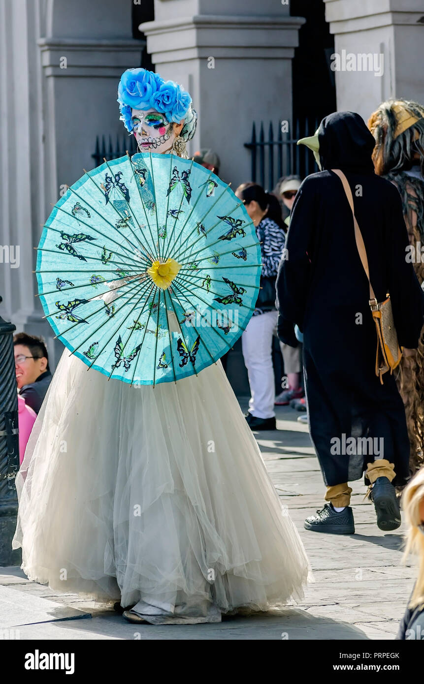 A street performer dressed as La Catrina stands outside St. Louis Cathedral in Jackson Square, November 11, 2015, in New Orleans, Louisiana. Stock Photo