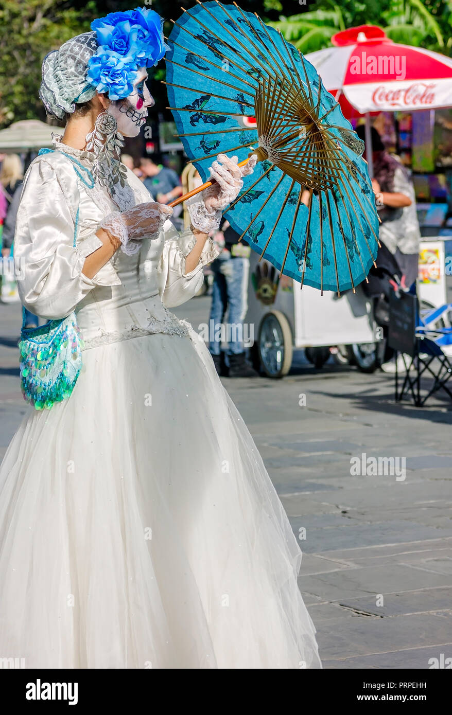 A street performer dressed as La Catrina stands outside St. Louis Cathedral in Jackson Square, November 11, 2015, in New Orleans, Louisiana. Stock Photo