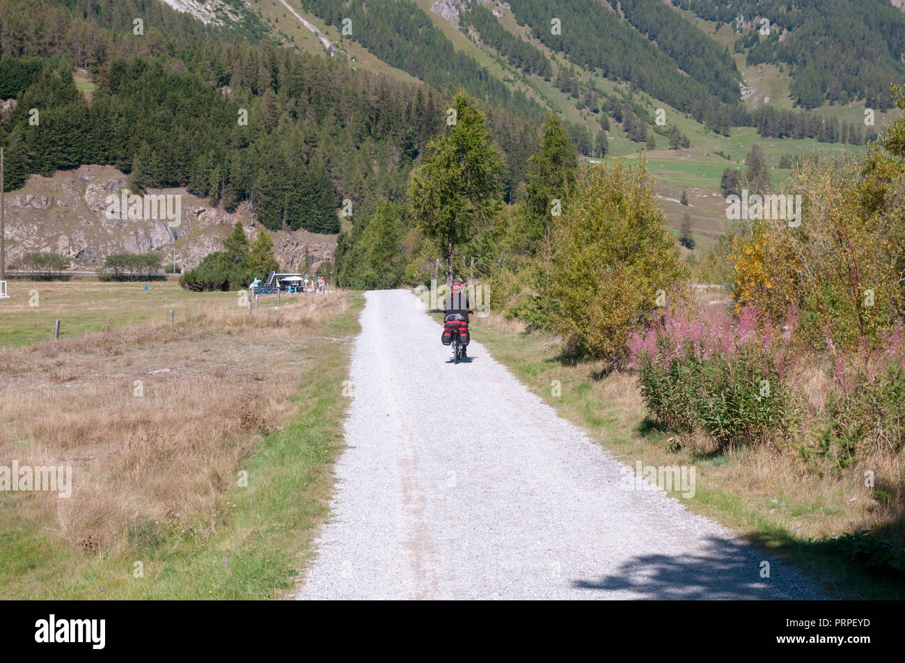 Cycling the Inn Valley, Engadine, Switzerland Photographed at Celerina, Maloja Region, Graubünden, Switzerland. Model release available Stock Photo