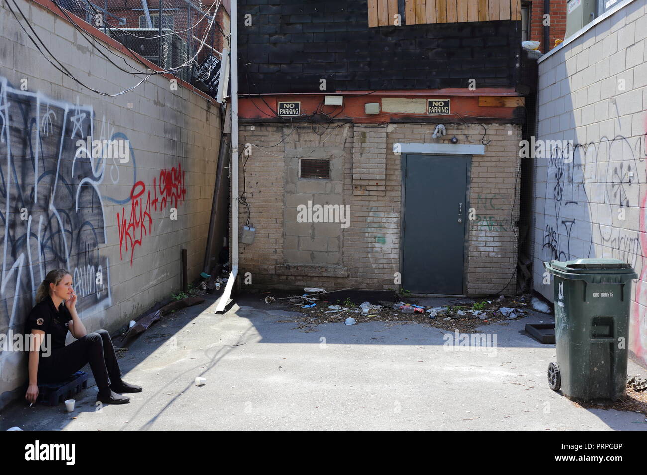 Shot of waitress taking a smoke break in a back alley at Yonge and Eglinton Stock Photo Alamy