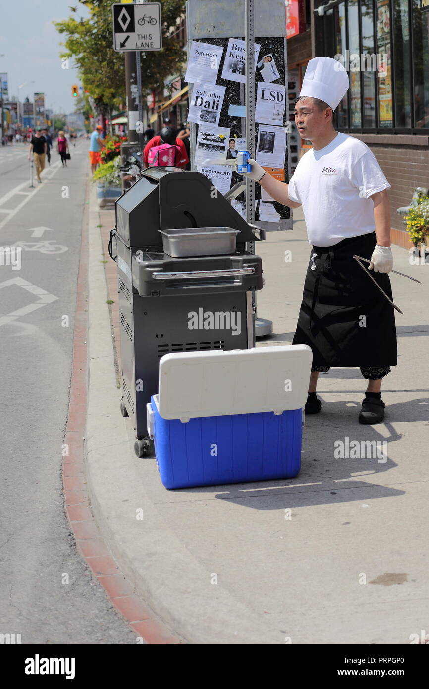 Man sells drinks to passers by during Open Streets at Yonge and Bloor, Toronto, Ontario, Canada. Stock Photo