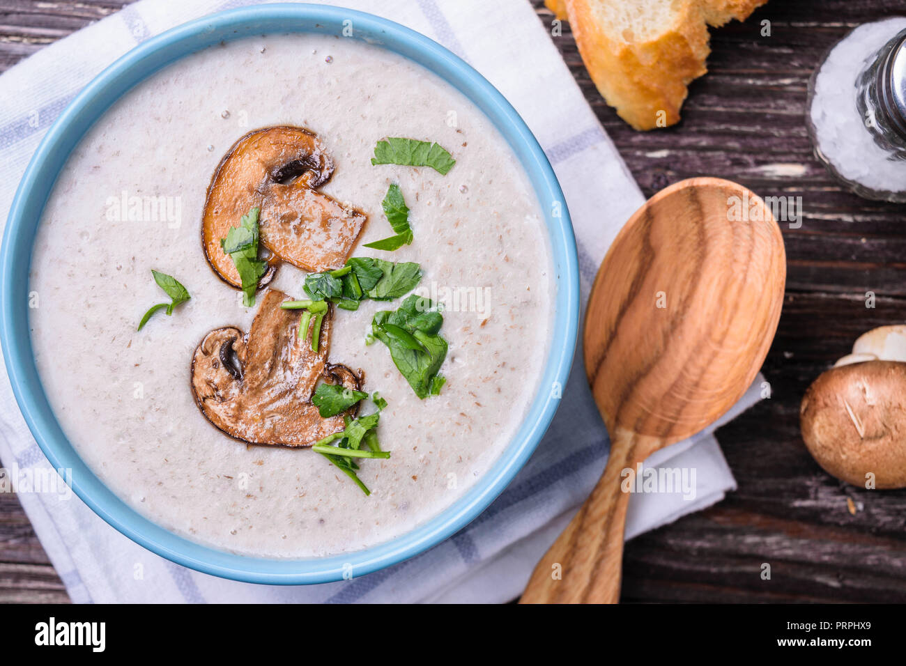 Delicious champignon mushroom cream soup puree on rustic wooden table. Top view. Close up view. Stock Photo