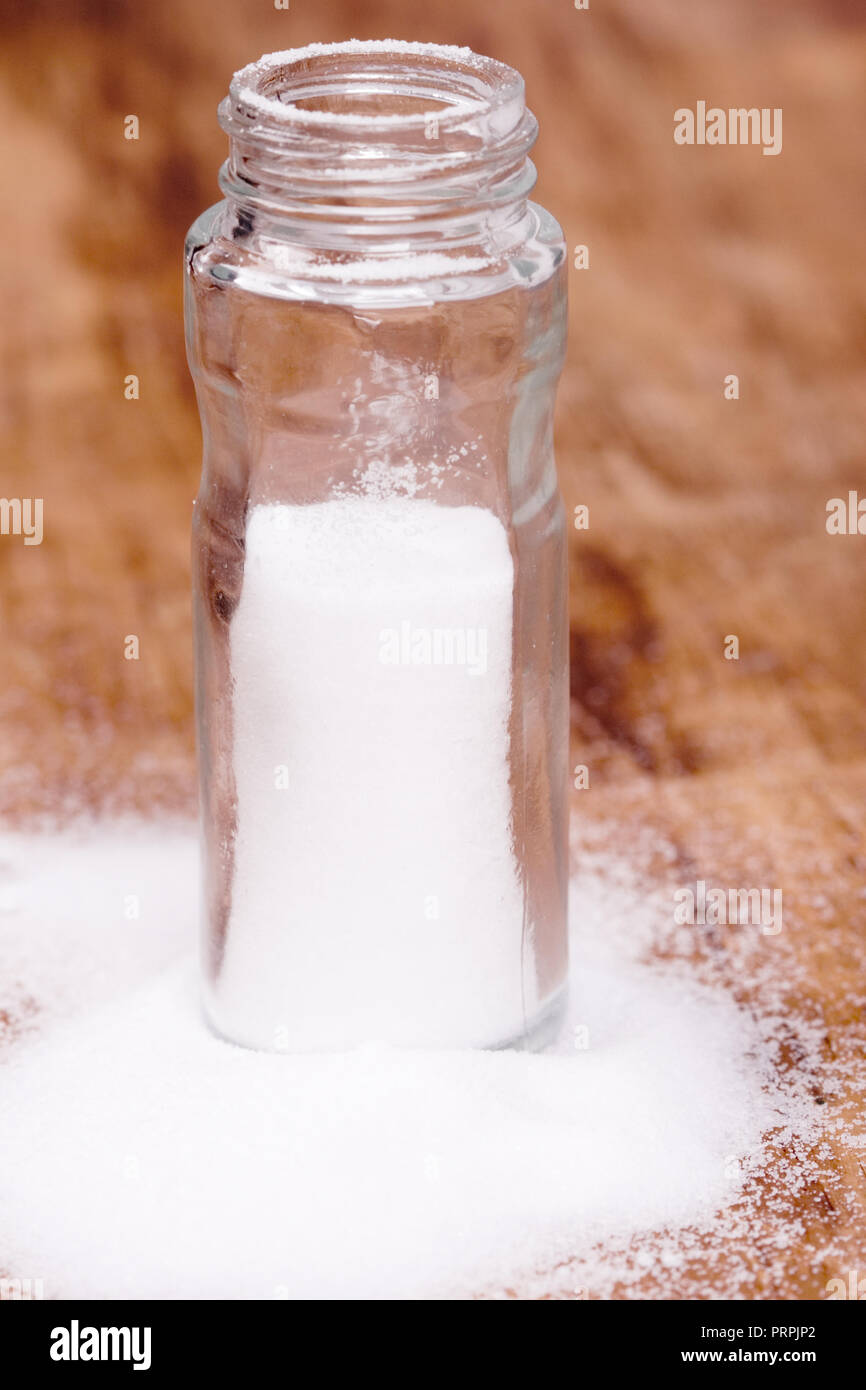 Open Container Salt salt in glass container closeup on wooden background Stock Photo - Alamy