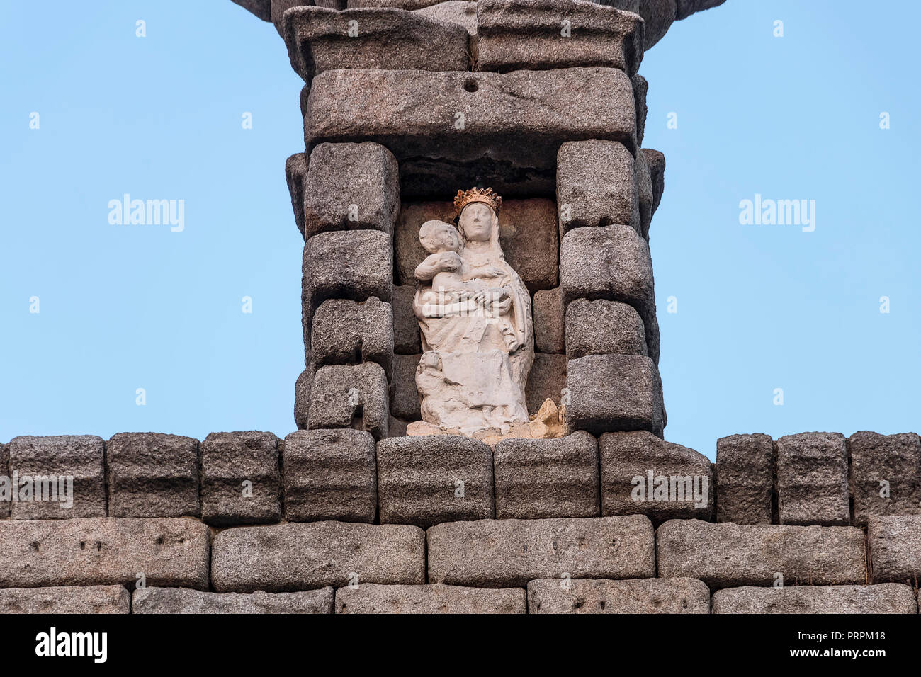 Detail of roman aqueduct, Virgin of the Aqueduct, located in the central niche of the monument has since the Plaza del Azoguejo, Segovia, Spain Stock Photo