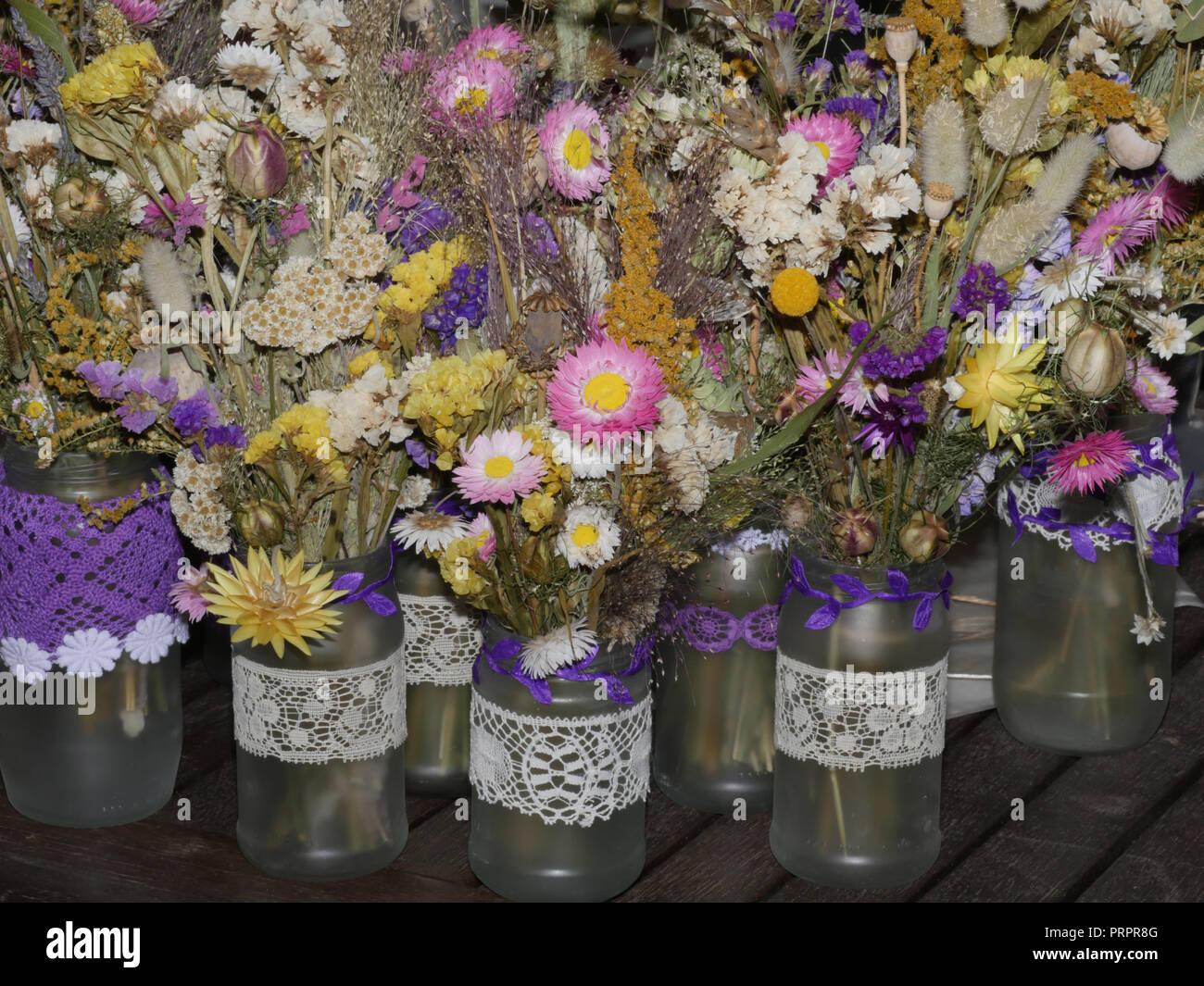 Dried flowers in jam jars for wedding tables Stock Photo Alamy