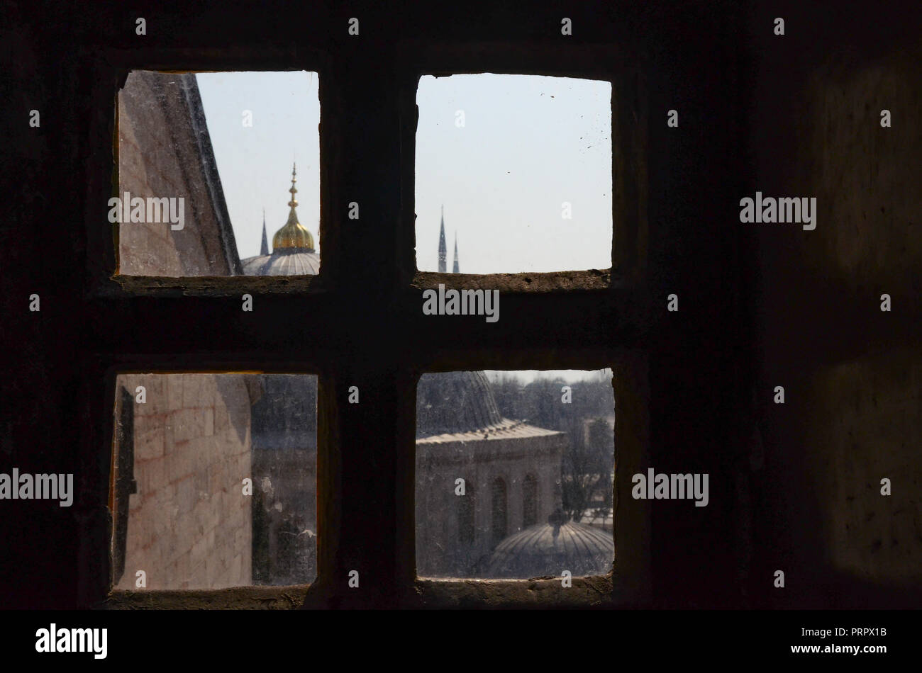 Scenic view of rooftops, Mosque Domes and Turkish architecture behind a window frame at Hagia Sophia, the former Greek Orthodox Christian patriarchal Stock Photo