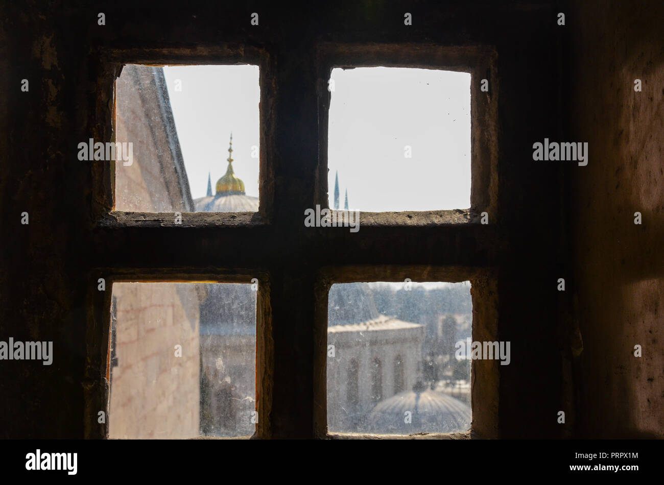 Scenic view of rooftops, Mosque Domes and Turkish architecture behind a window frame at Hagia Sophia, the former Greek Orthodox Christian patriarchal Stock Photo