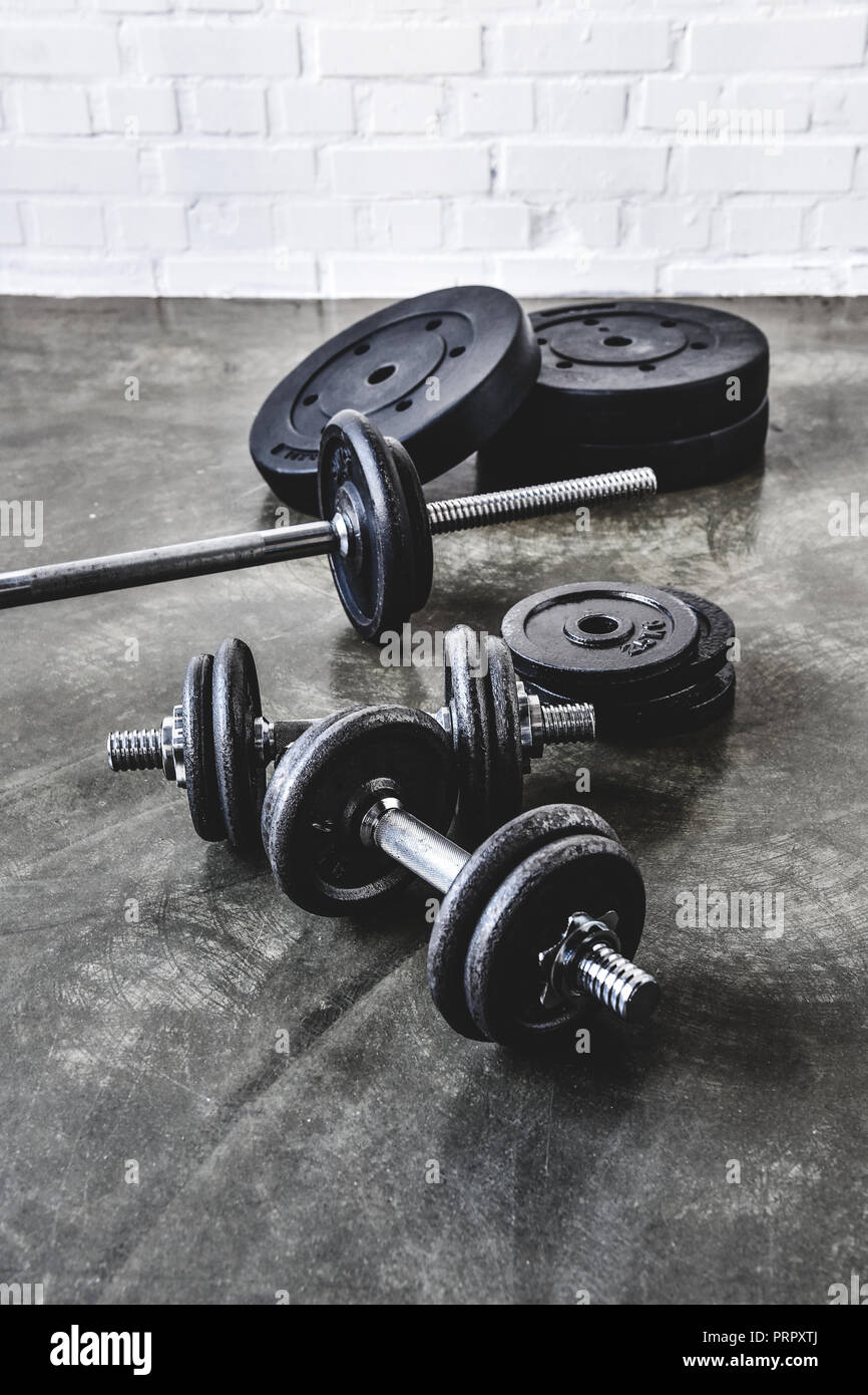 various gym equipment on concrete surface Stock Photo