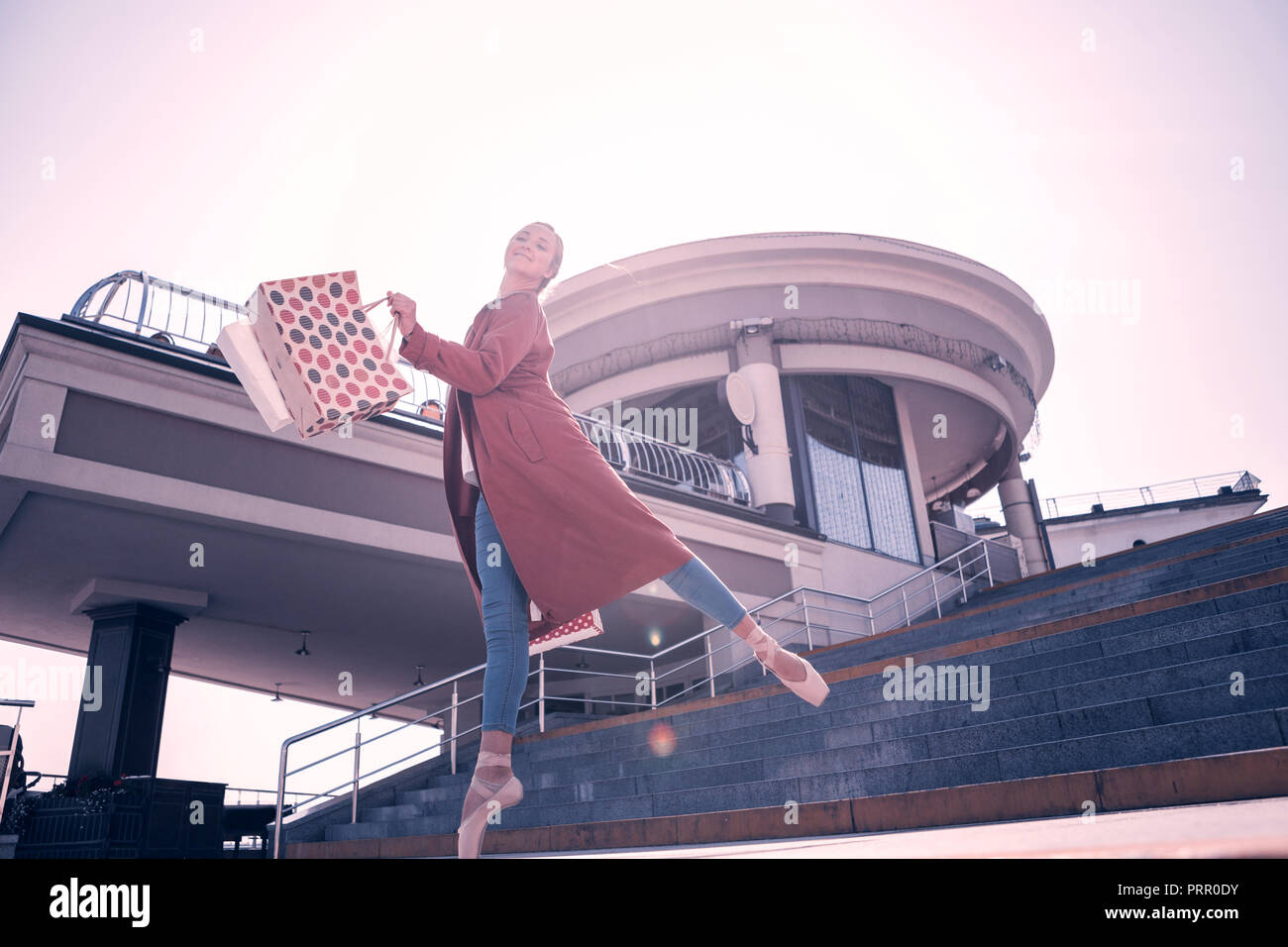 Attractive nice ballerina walking down the stairs Stock Photo