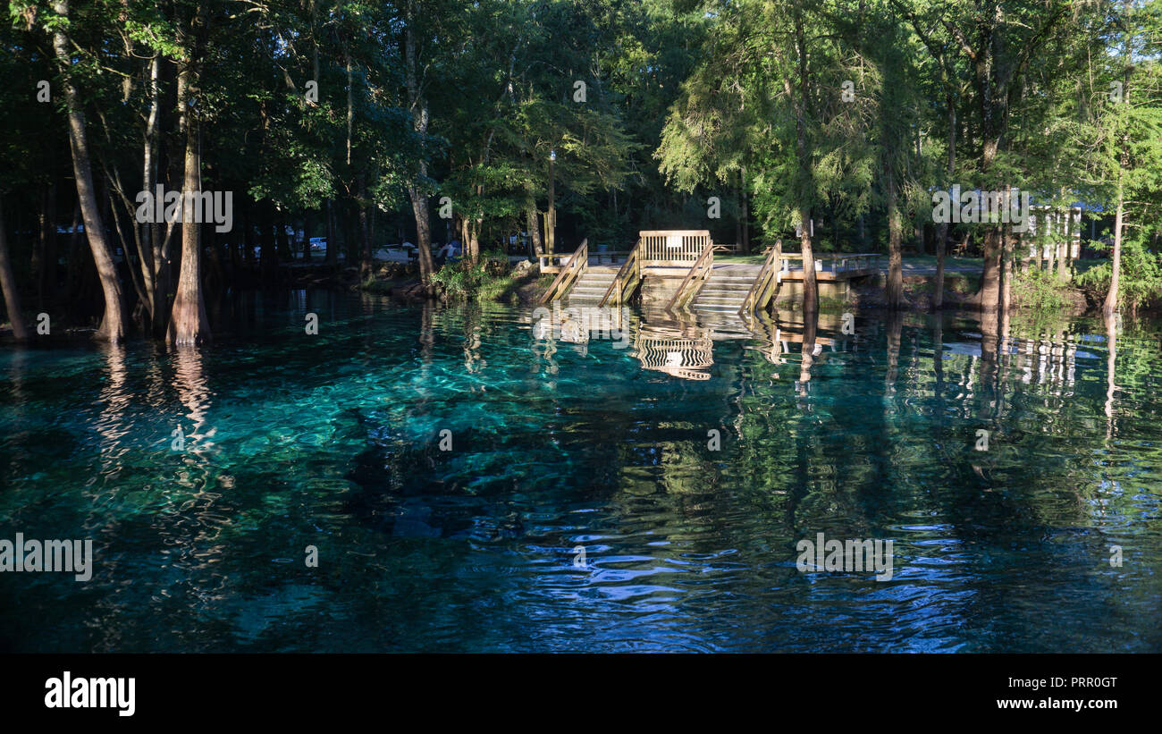 Wooden staircase going down in the turquoise water in a lagoon of