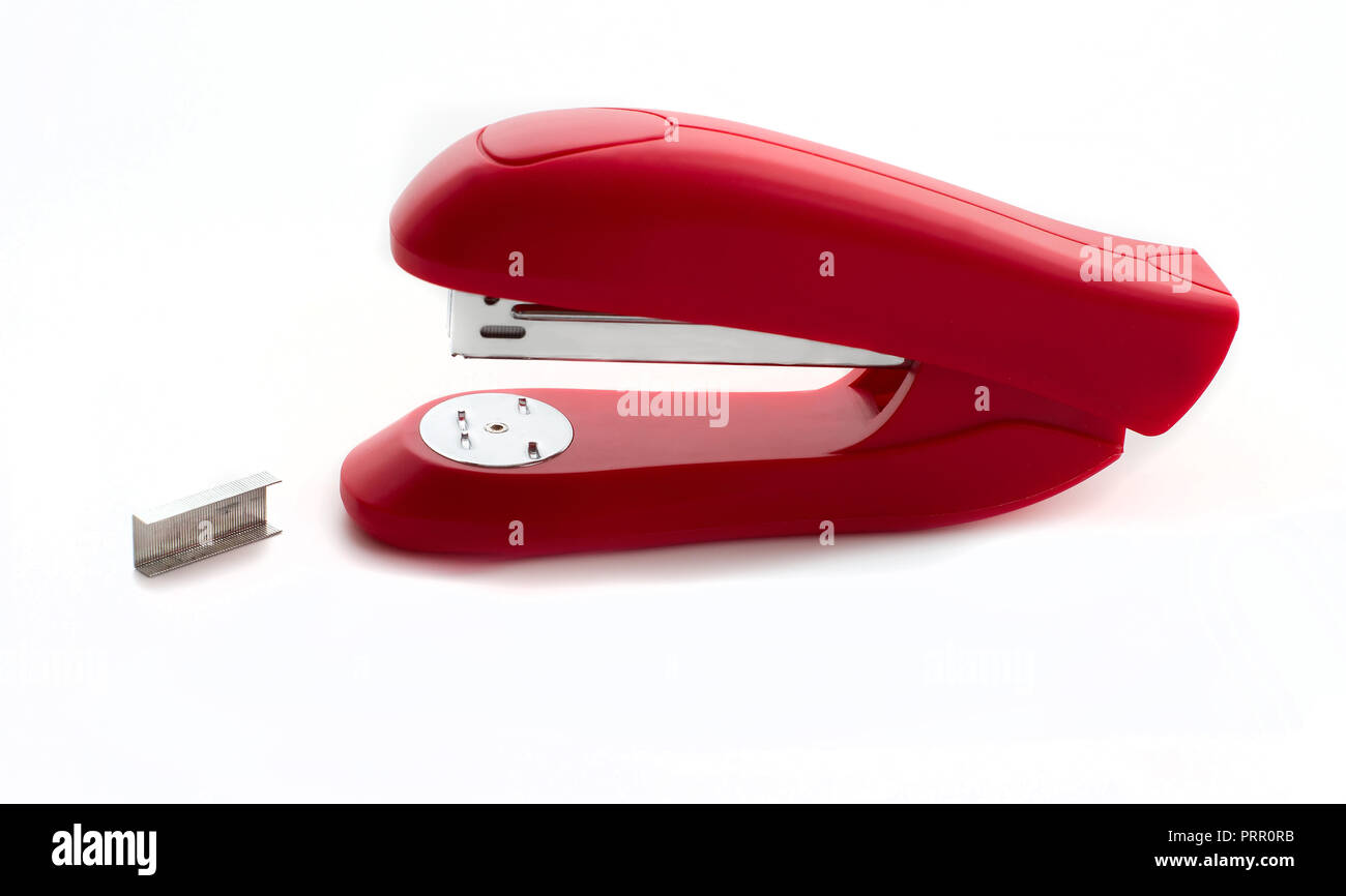 Red stapler with metal staples close up isolated on white background Stock Photo