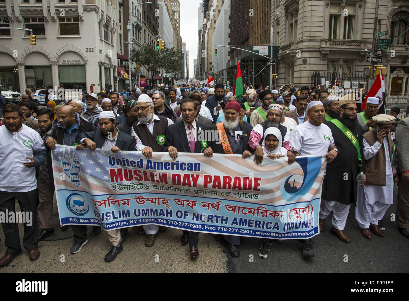 Grand Marshal and other dignitaries carry the official banner in the American Muslim Day Parade on Madison Avenue in New York City. Stock Photo