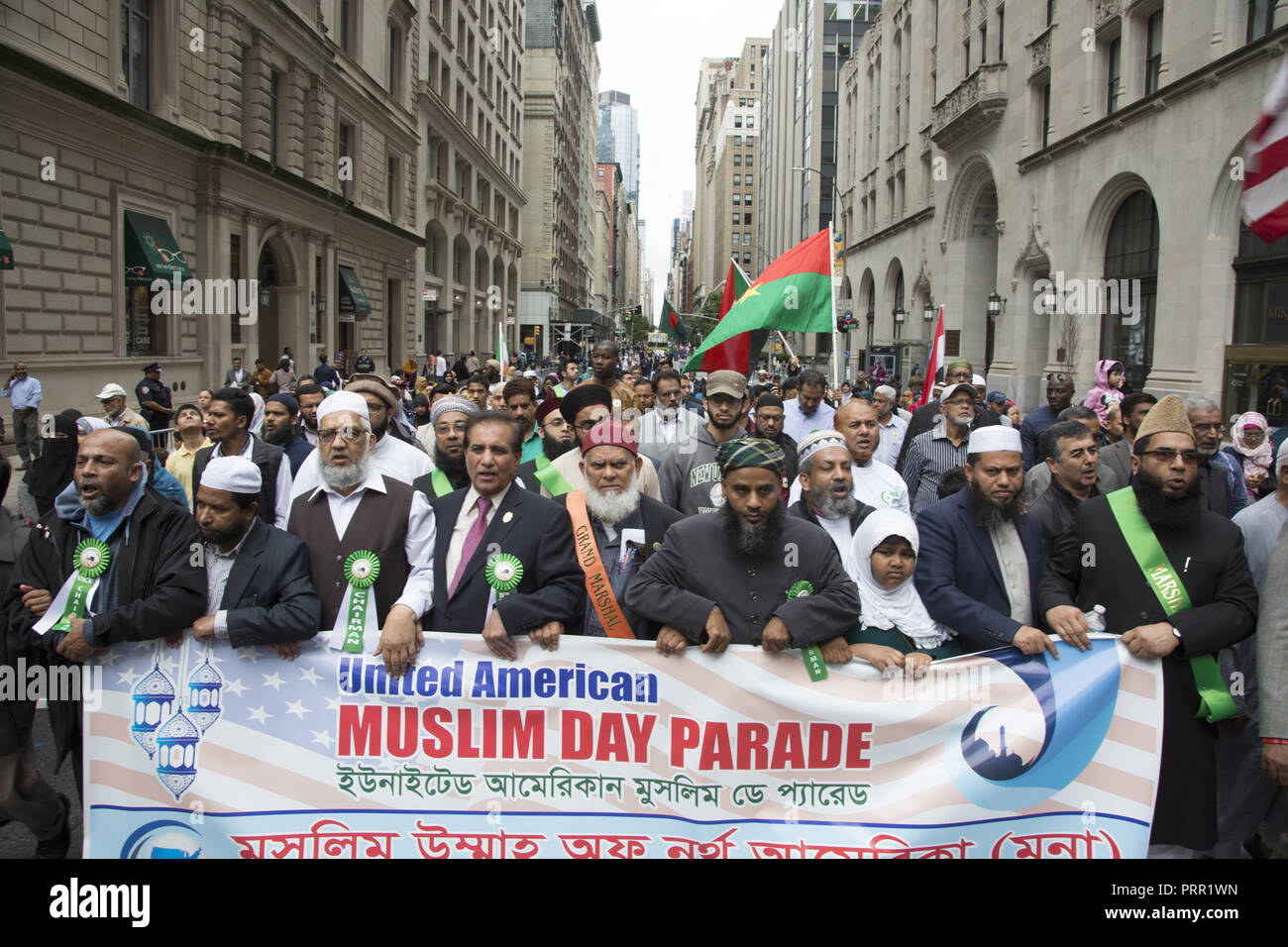 Grand Marshal and other dignitaries carry the official banner in the American Muslim Day Parade on Madison Avenue in New York City. Stock Photo