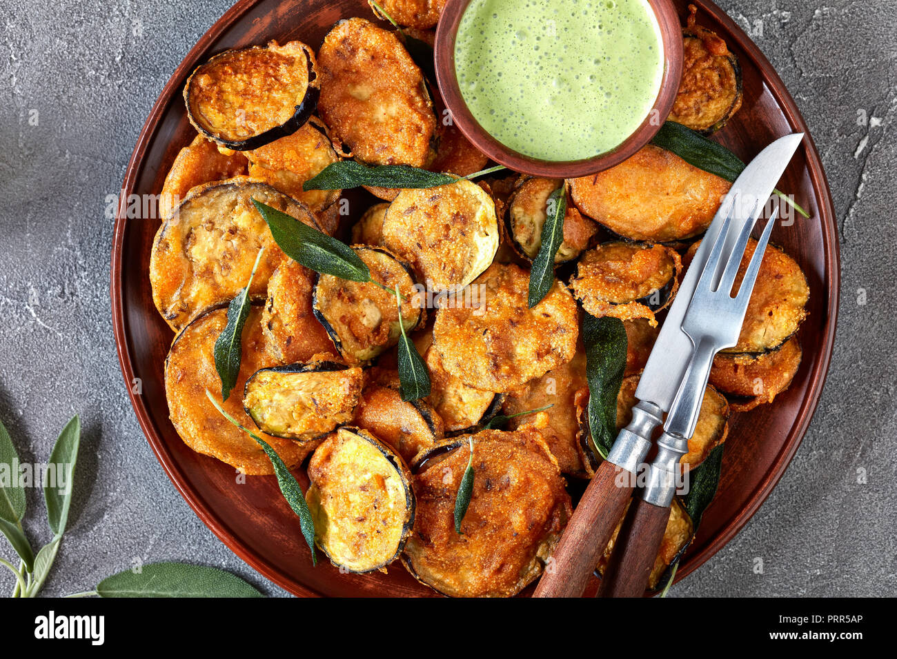 breaded deep Fried Eggplant Aubergine slices on a earthenware plate