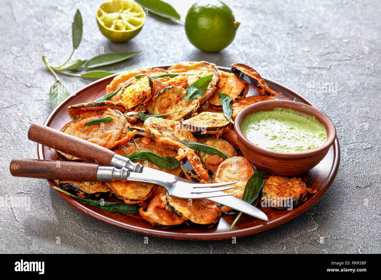 breaded deep Fried Eggplant Aubergine slices on a earthenware plate