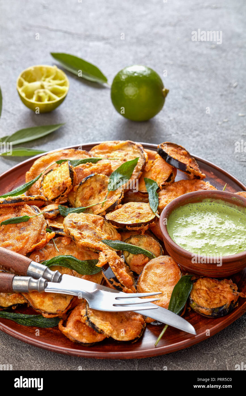 breaded deep Fried Eggplant Aubergine slices on a earthenware plate