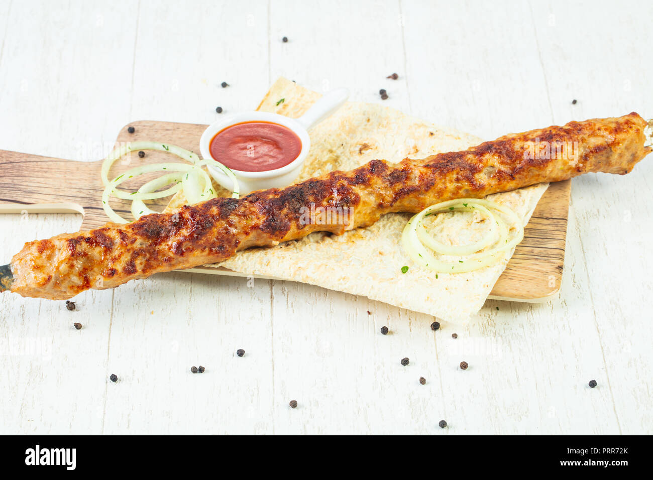 Grilled minced chicken kebab with sauce and onion Stock Photo Alamy