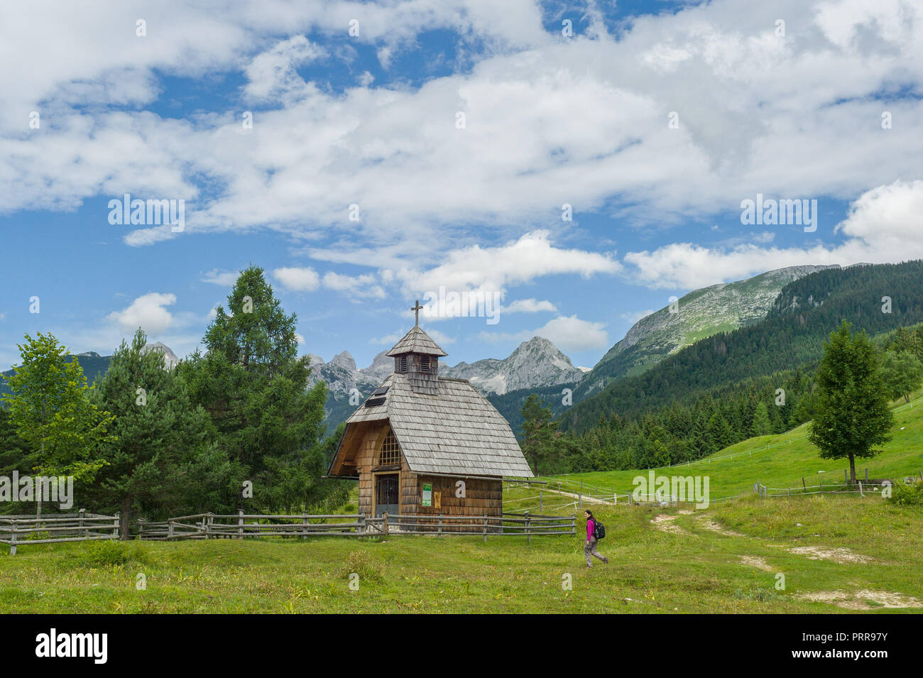 A chapel on the outskirts of Uskovnica, pokljuka plateau with Triglav mountain behind.  Julian Alps Slovenia Stock Photo