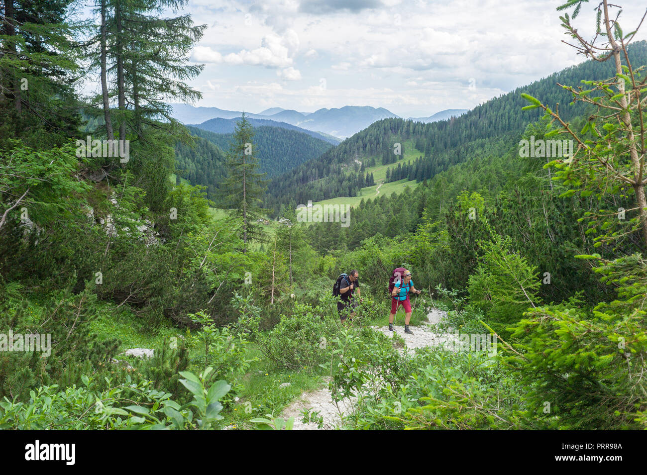hikers on the path above Konjščica on route to Triglav mountain in Triglav National Park, Julian Alps, Slovenia. Stock Photo
