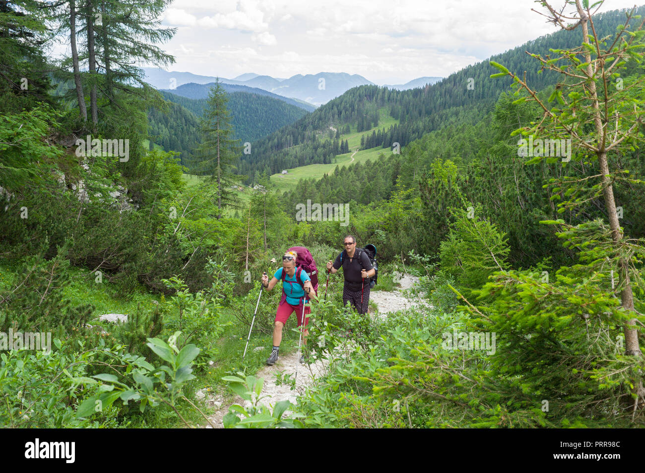 hikers on the path above Konjščica on route to Triglav mountain in Triglav National Park, Julian Alps, Slovenia. Stock Photo