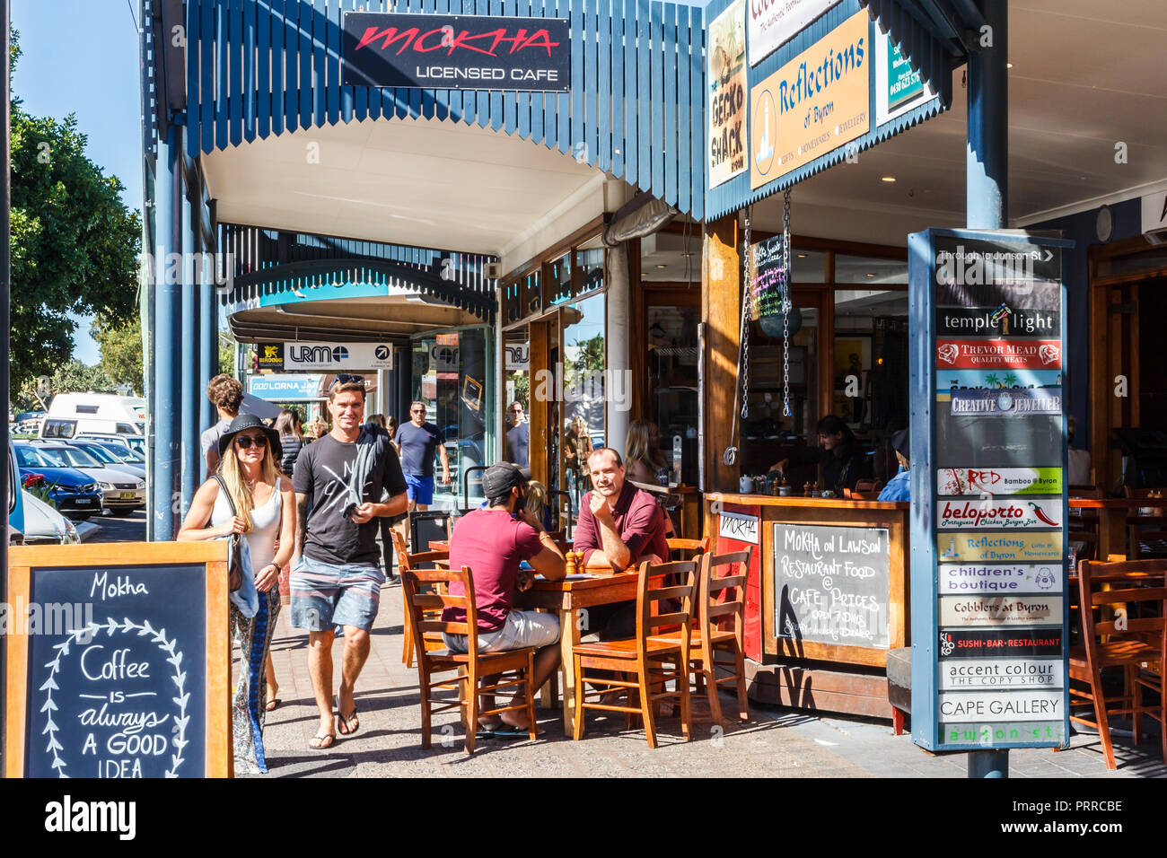 Byron Bay, Australia - 14th May 2015: People walking past and sitting in coffee shop. The town is popular with young people. Stock Photo