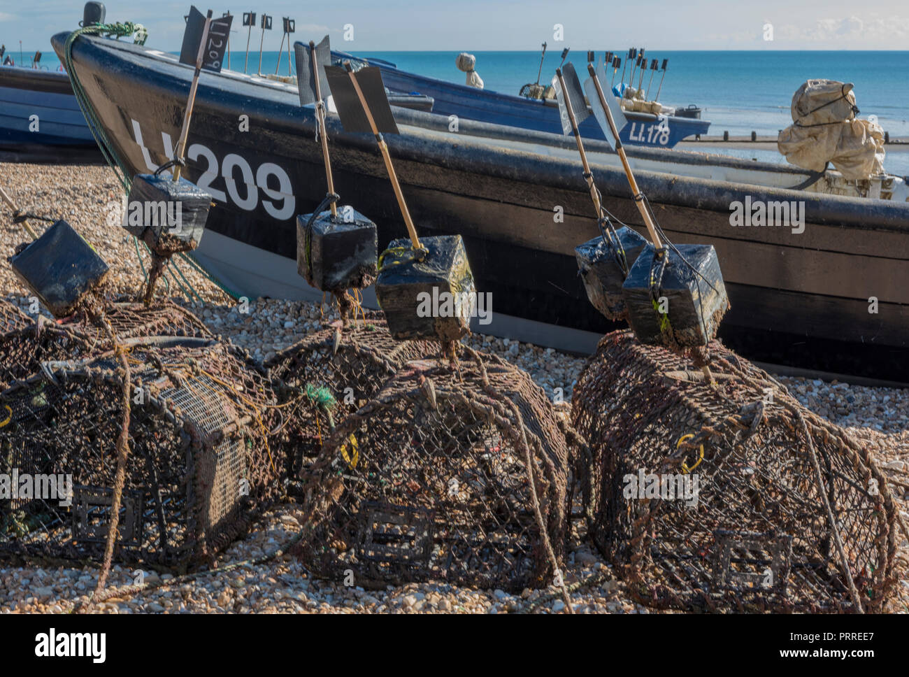 traditional open wooden fishing boats on the shingle beach at Bognor ...