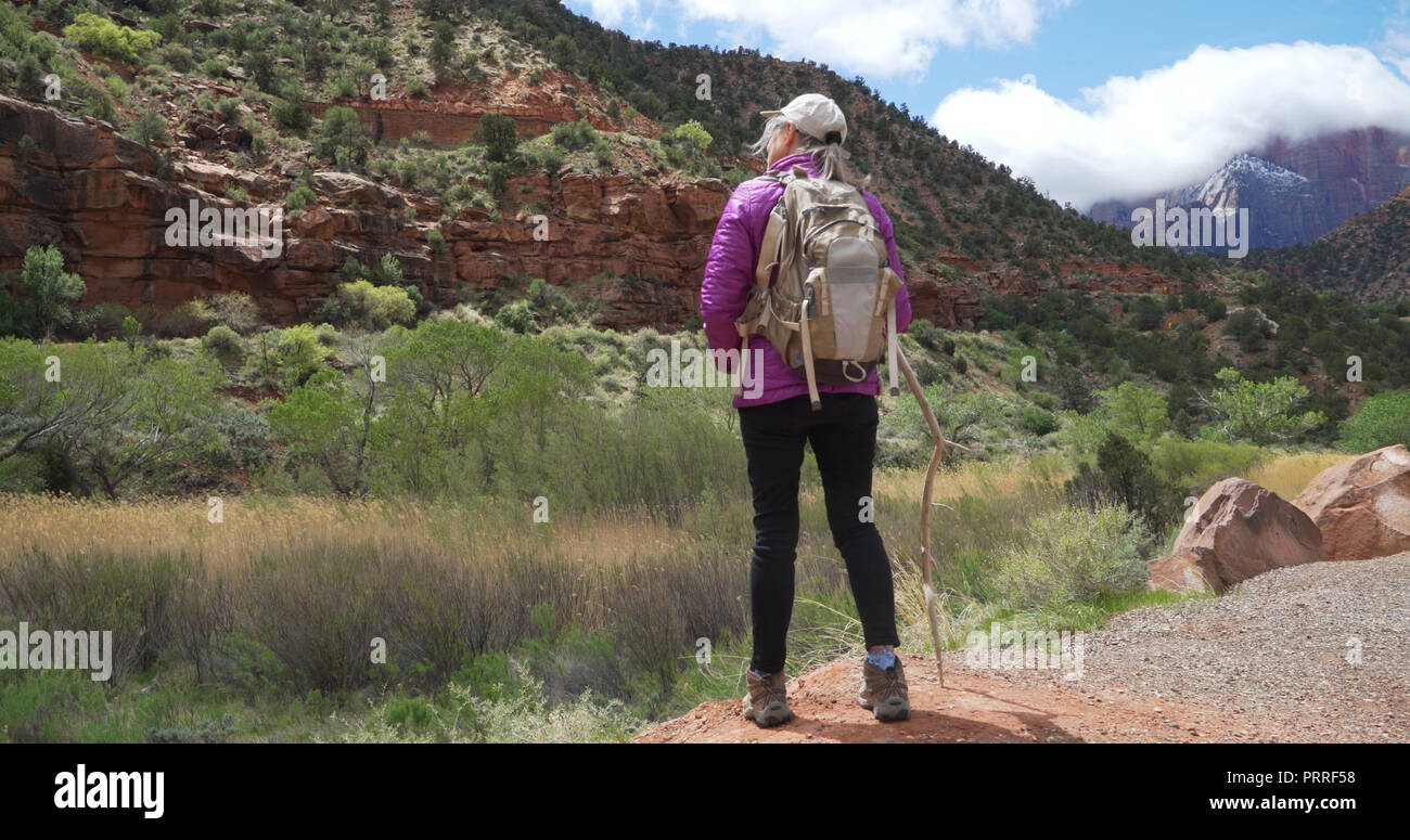Youthful senior woman admiring canyon landscape of Zion Utah Stock Photo