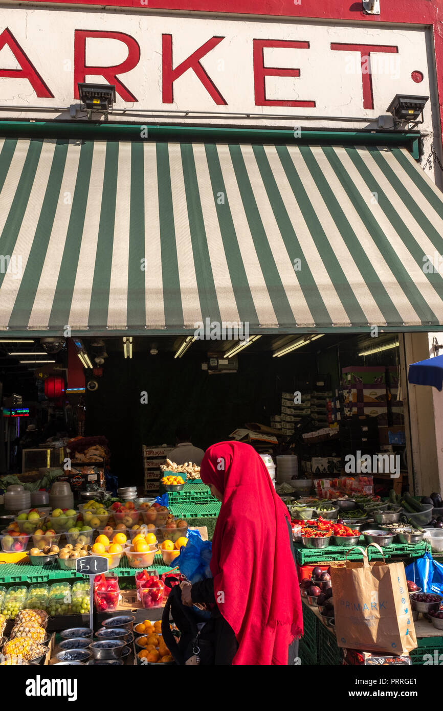 UK,London,South London, wooman in red headscarf shopping at Tooting market Stock Photo