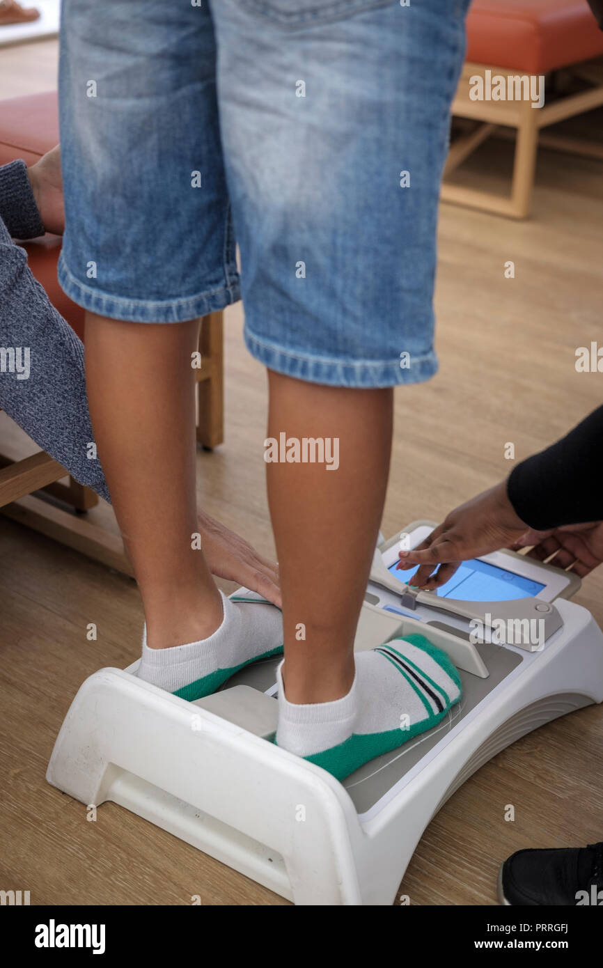 Boy has his feet measured with electronic Brannock device to determine shoe size in a shoe shop Stock Photo