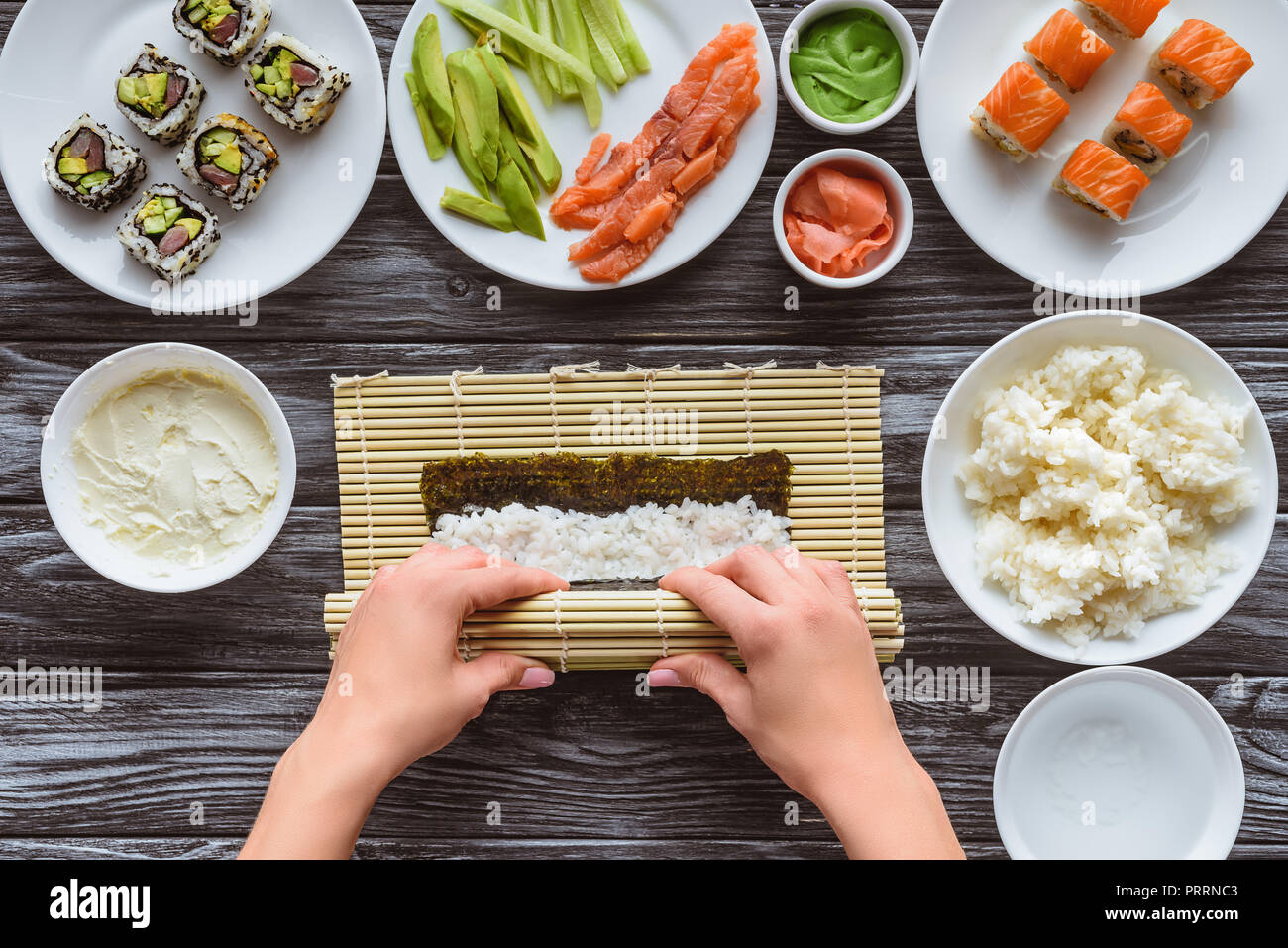 partial top view of person cooking gourmet sushi roll Stock Photo