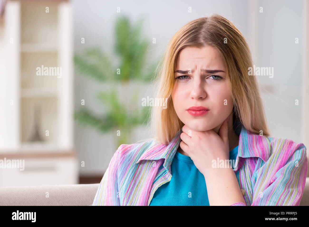 Young woman suffering from sore throat pain Stock Photo Alamy