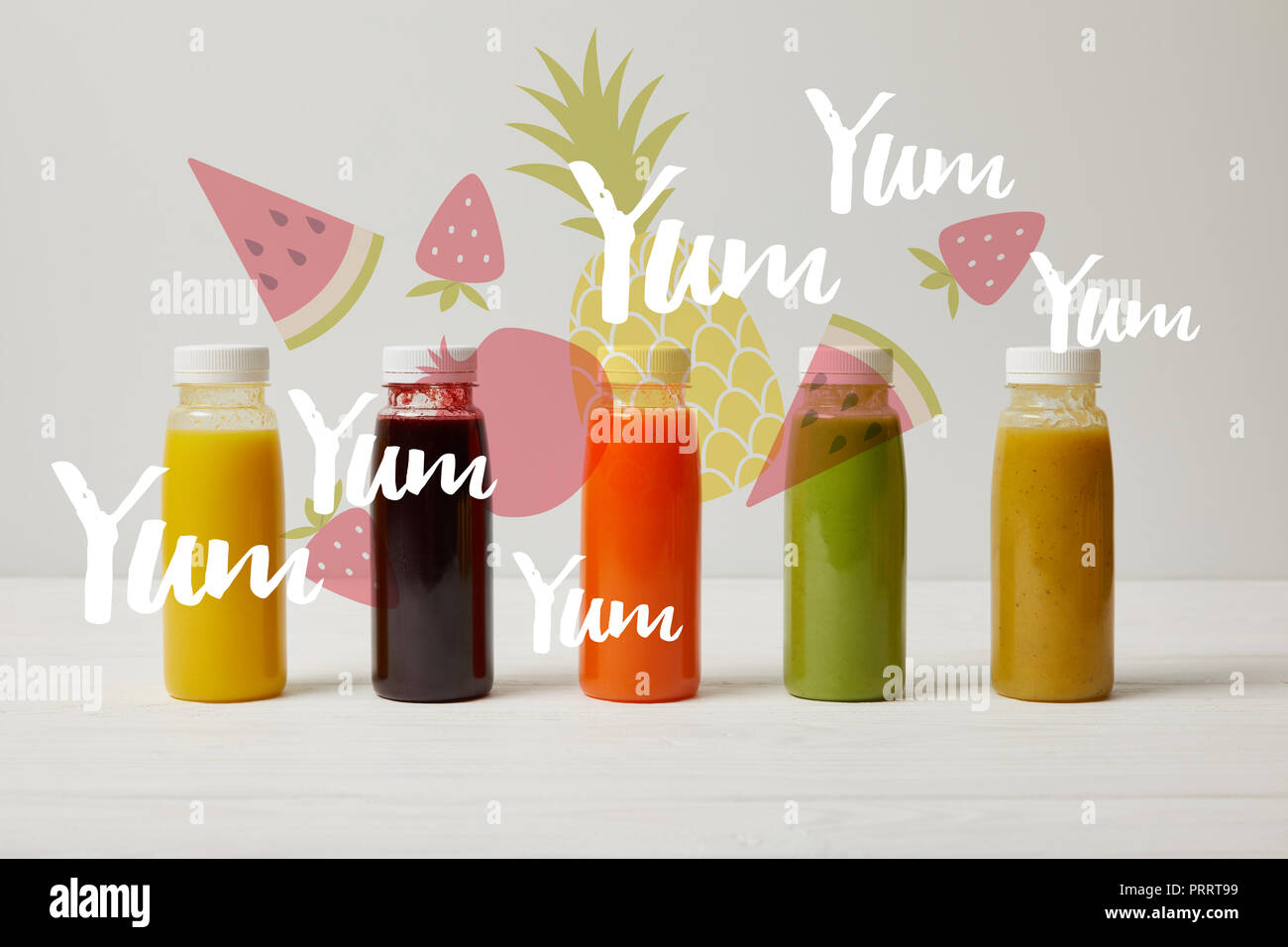 detox smoothies in bottles standing in row, refresh concept, yum yum yum inscription Stock Photo