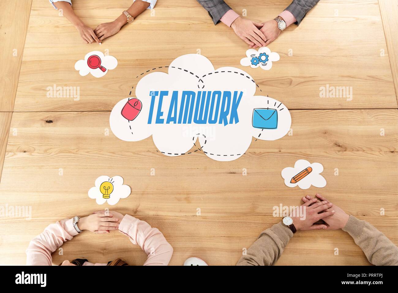 overhead view of multiracial business people at wooden table with blank ...