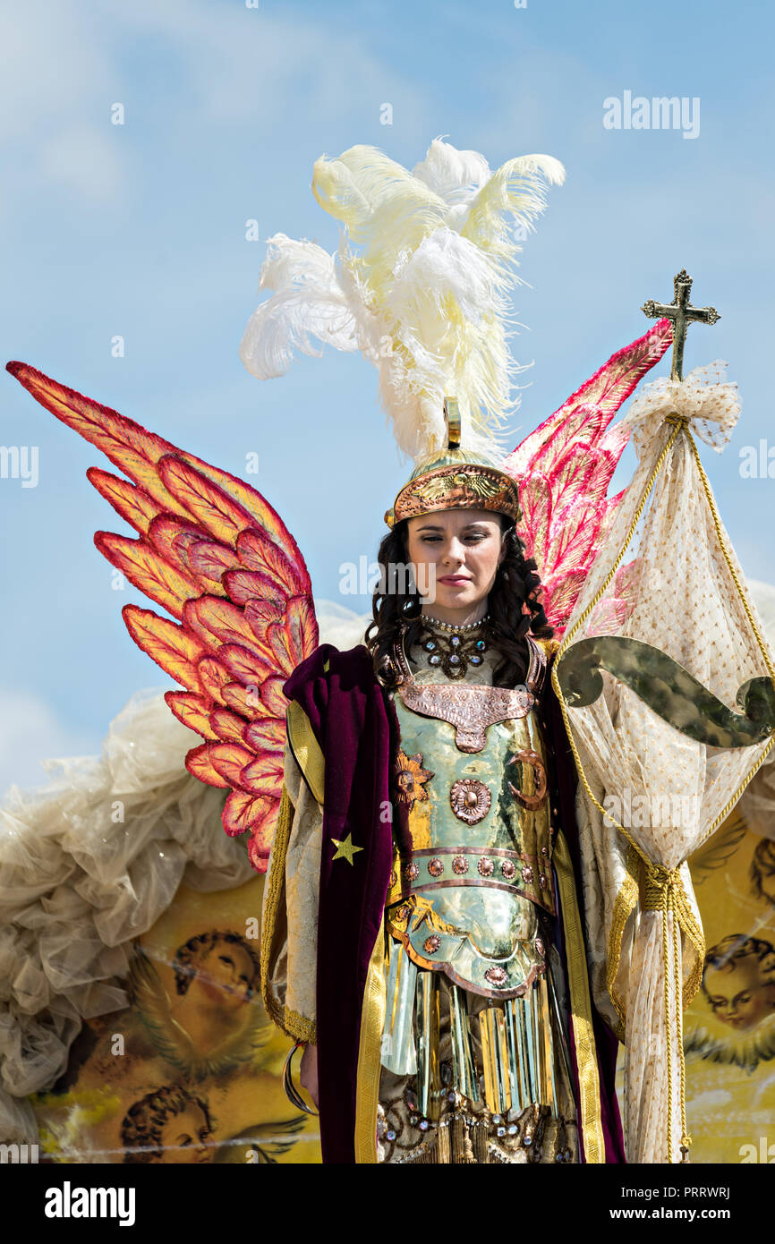 A young Mexican woman dressed as Saint Michael the Archangel during the annual parade celebrating the cities patron saint September 30, 2018 in San Miguel de Allende, Mexico. The festival is a four-day long event with processions, parades and a late night fireworks battle. Stock Photo