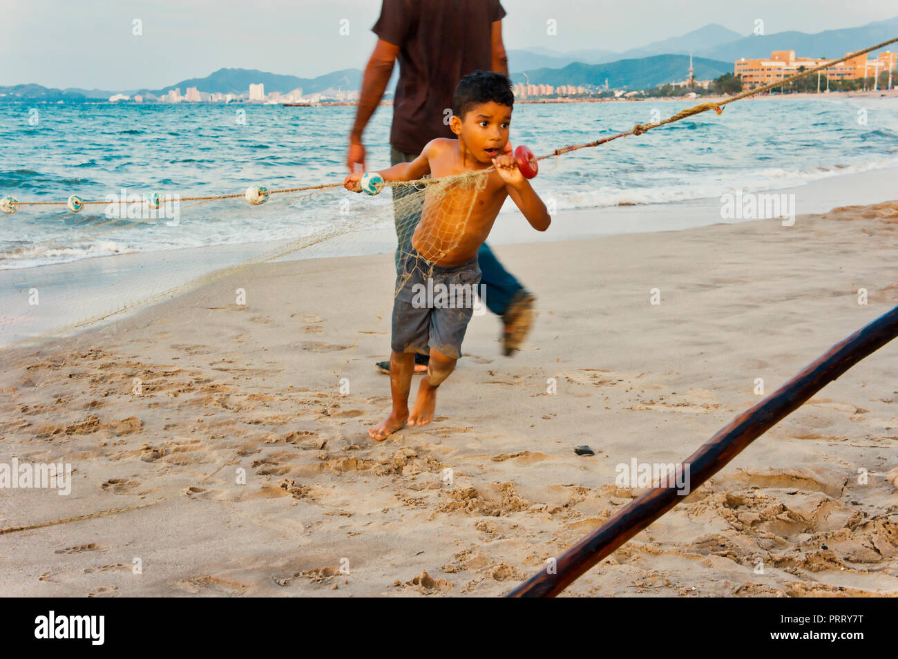 Six year old boy on dock holding tiny fish on the end of his fishing line  Stock Photo - Alamy