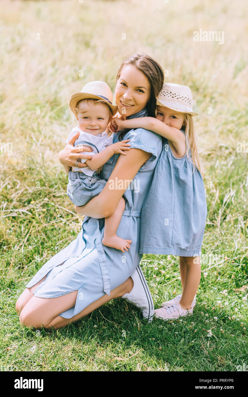 beautiful mother spending time with children in field Stock Photo