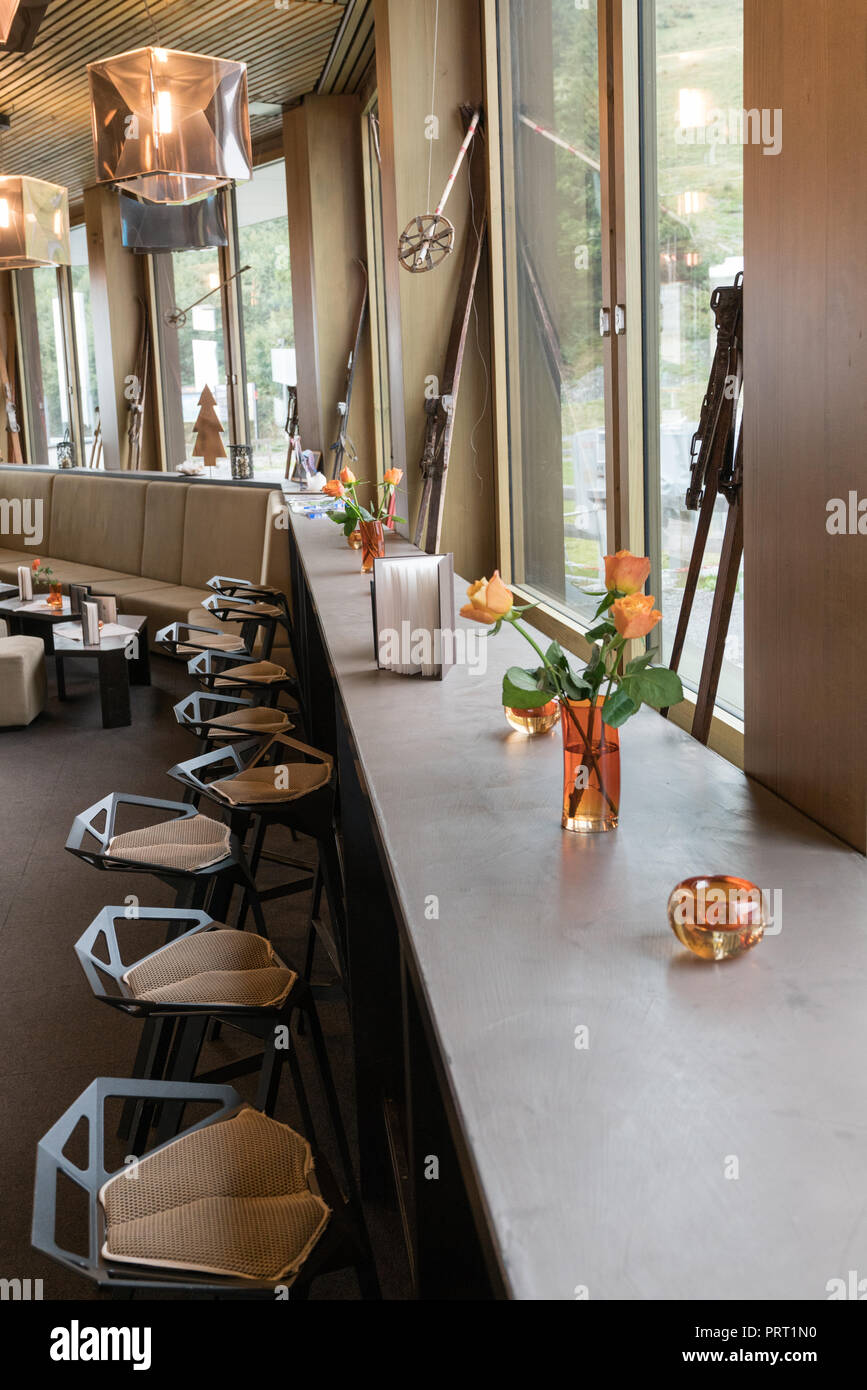 elegant and inviting bar and lounge with a long table along a window ...