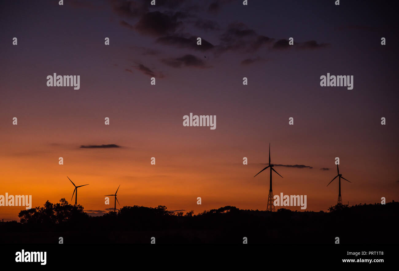 Wind turbines silhouette on mountain at sunset Stock Photo - Alamy