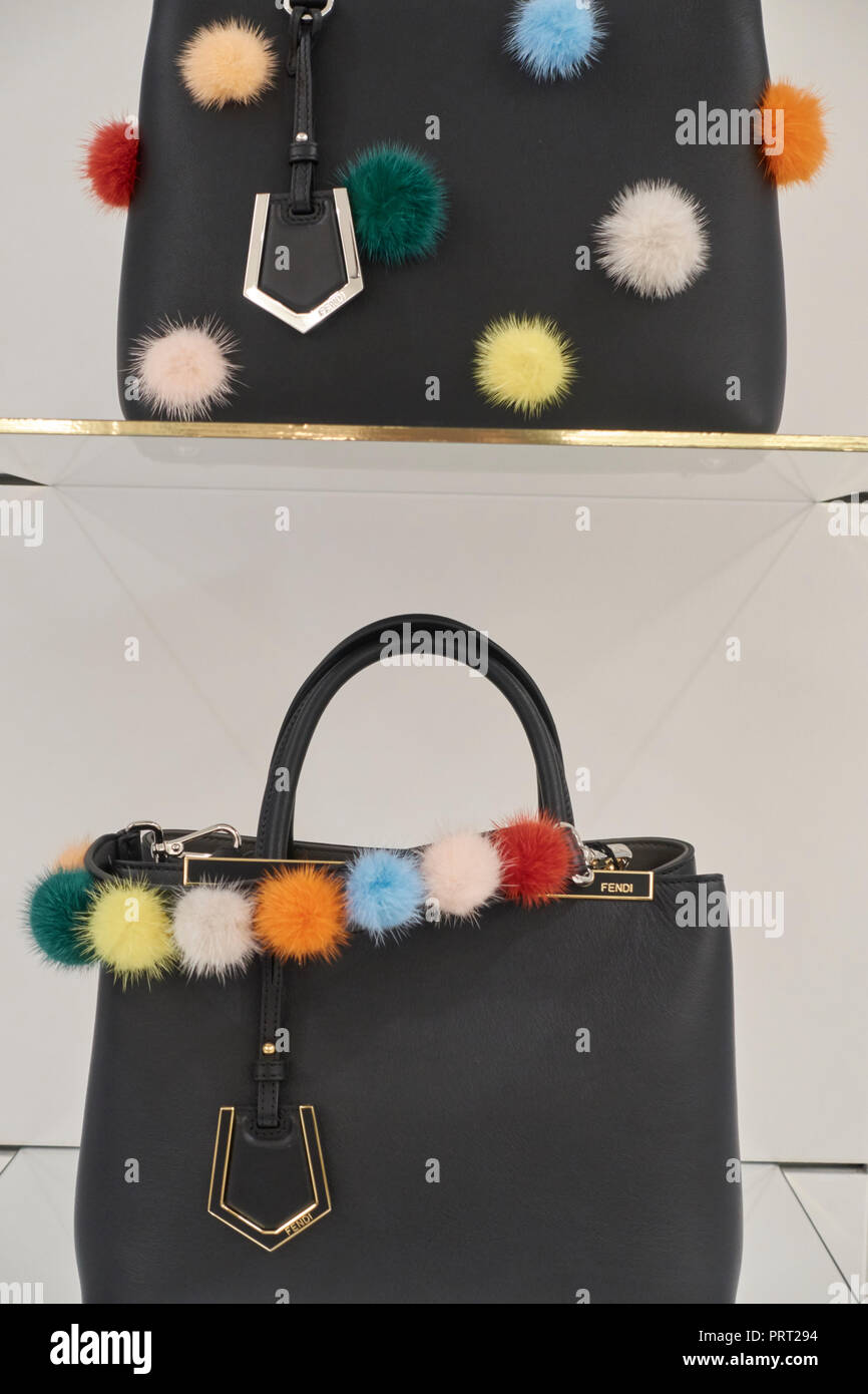 Fendi bags and shoes with pon pon on the shelves of a fashion store Stock Photo