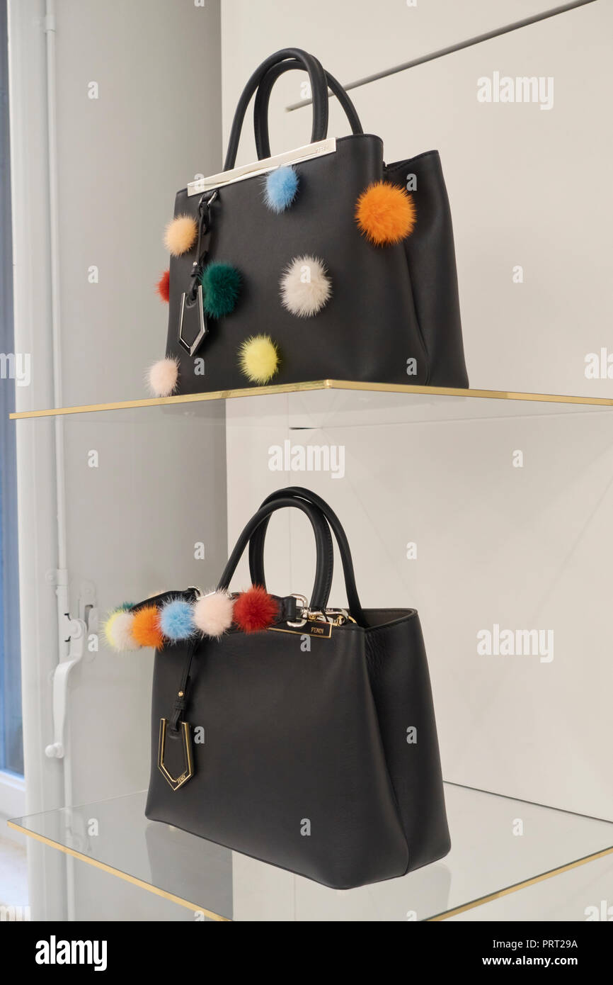 Fendi bags and shoes with pon pon on the shelves of a fashion store Stock Photo