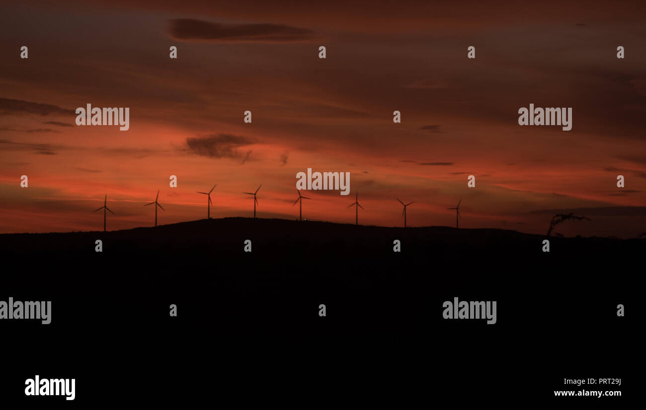 Wind turbines silhouette on mountain at sunset Stock Photo - Alamy