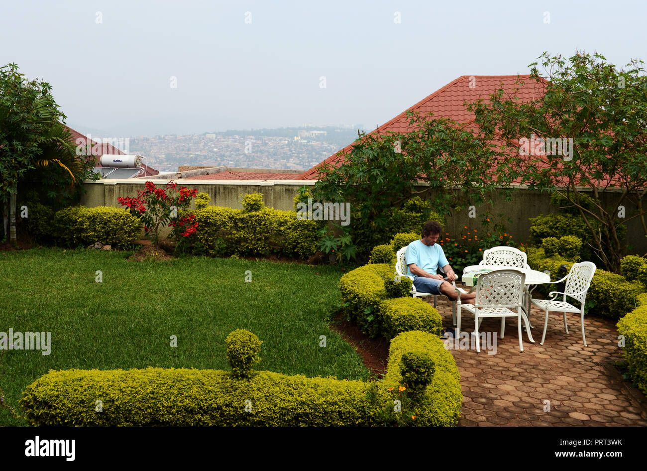 A tourist resting in the beautiful garden of the Yambi hotel in Kigali