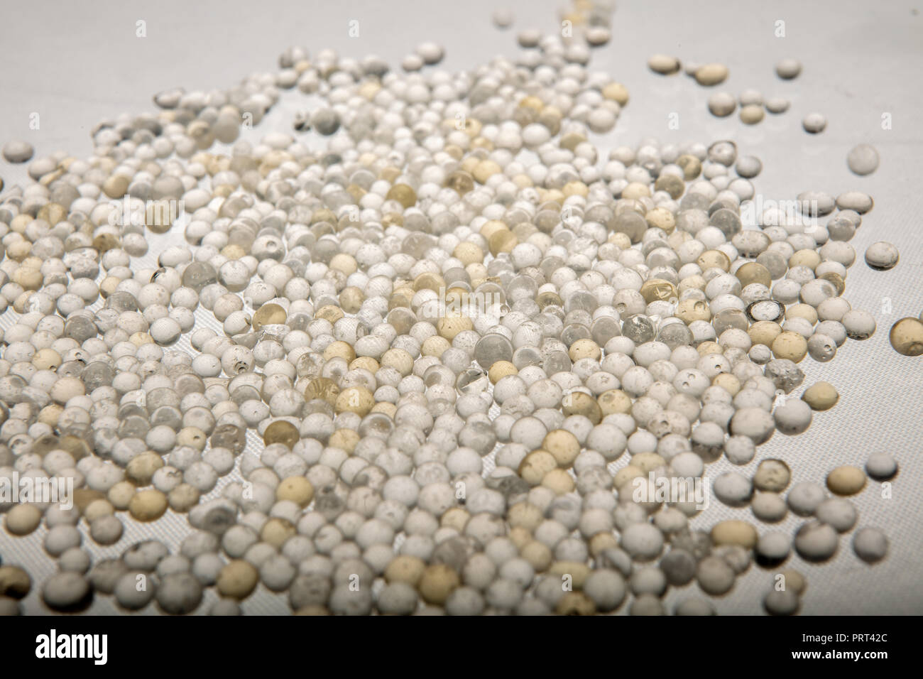 Macro of silica gel balls laying on white background.Its use to prevent