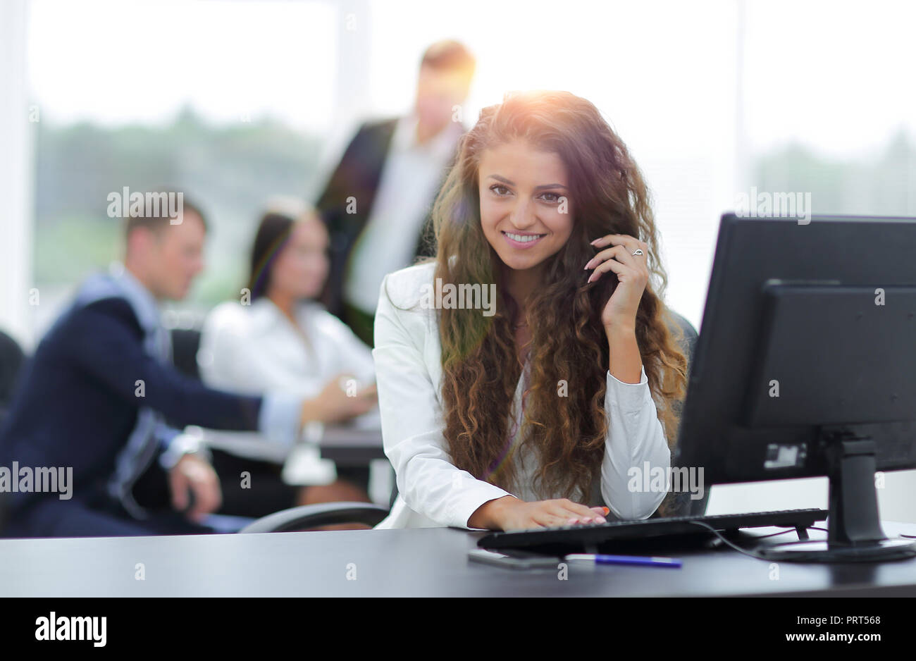 Manager woman sitting behind a Desk Stock Photo