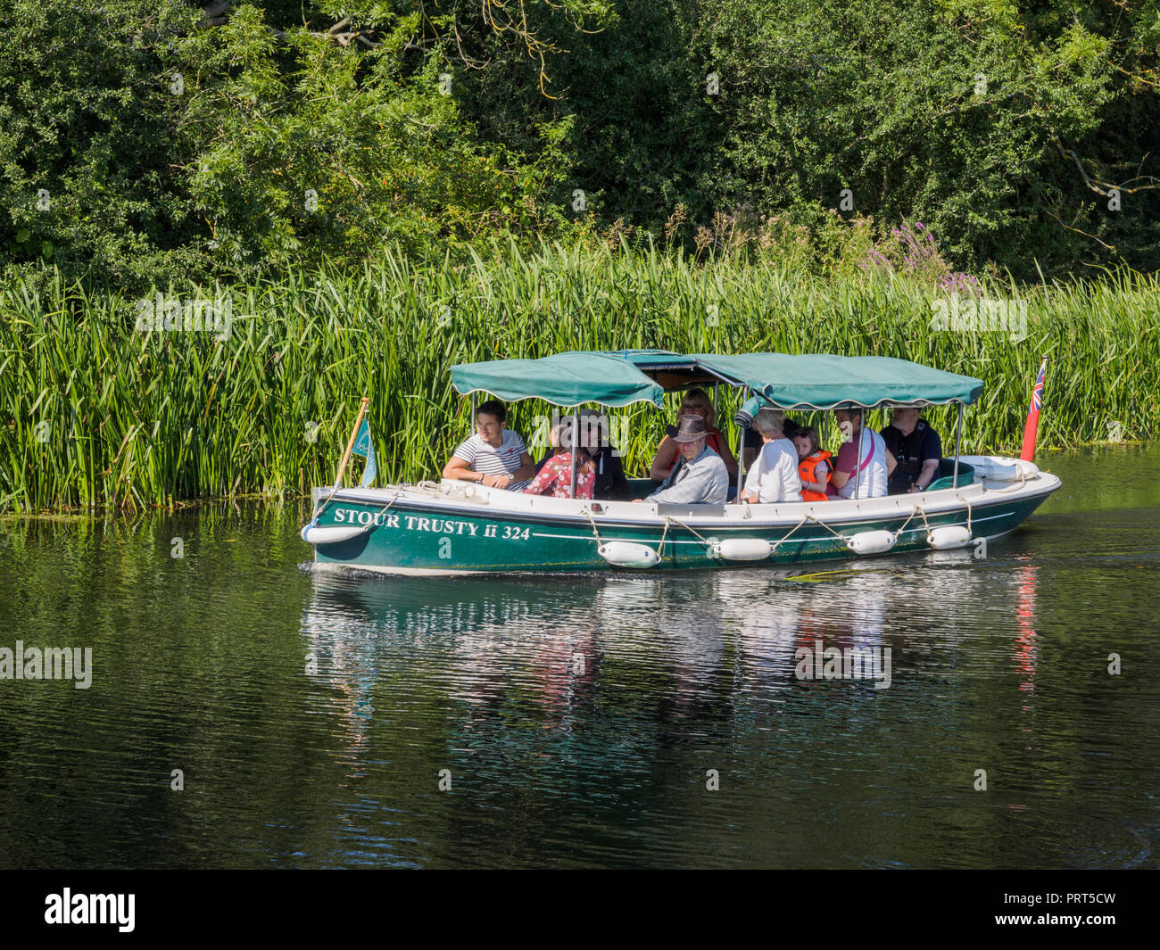 Electric cruise boat on the RIver Stour between Dedham and Flatford Stock Photo
